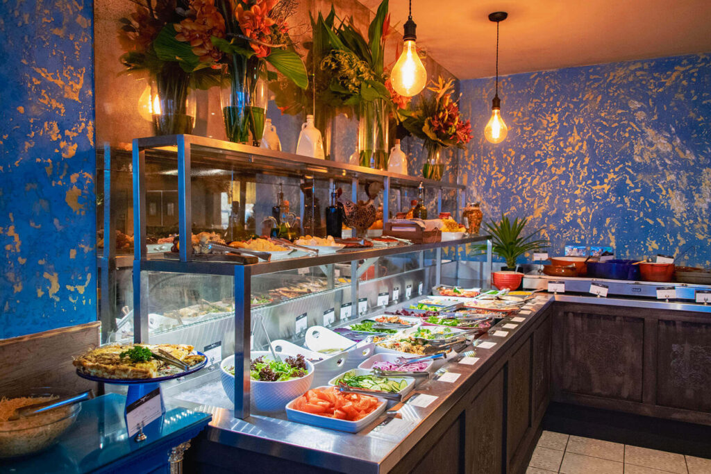 A lavish salad bar and buffet featuring an array of delicious dishes artfully displayed for guests to enjoy.