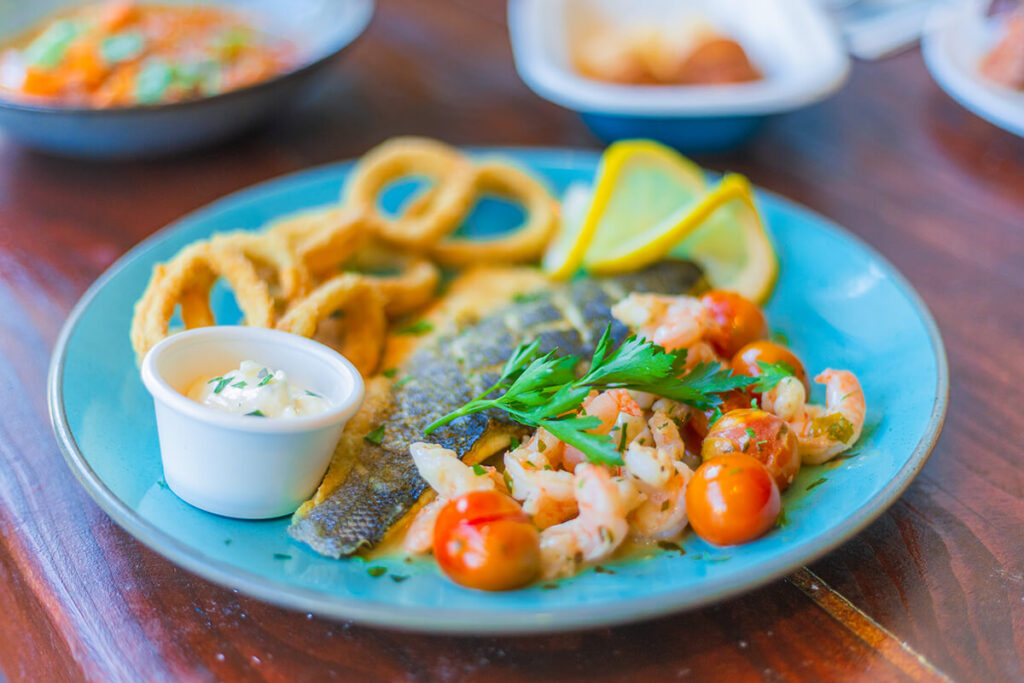 Seafood Rodizio dish at Casa Brazilian Rodizio York featuring grilled fish, calamari rings, cherry tomatoes and lemon garnish