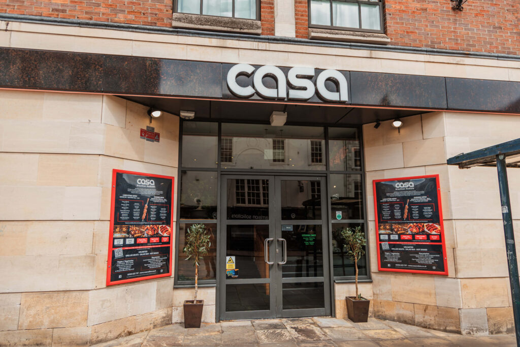 Front entrance of Casa Brazilian Rodizio restaurant on Micklegate in York with menus displayed outside.