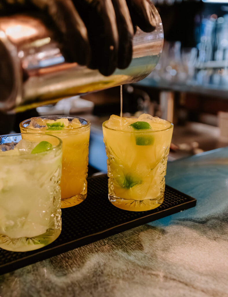 Brazilian Caipirinha cocktails with lime being poured at Casa Rodizio bar in York.