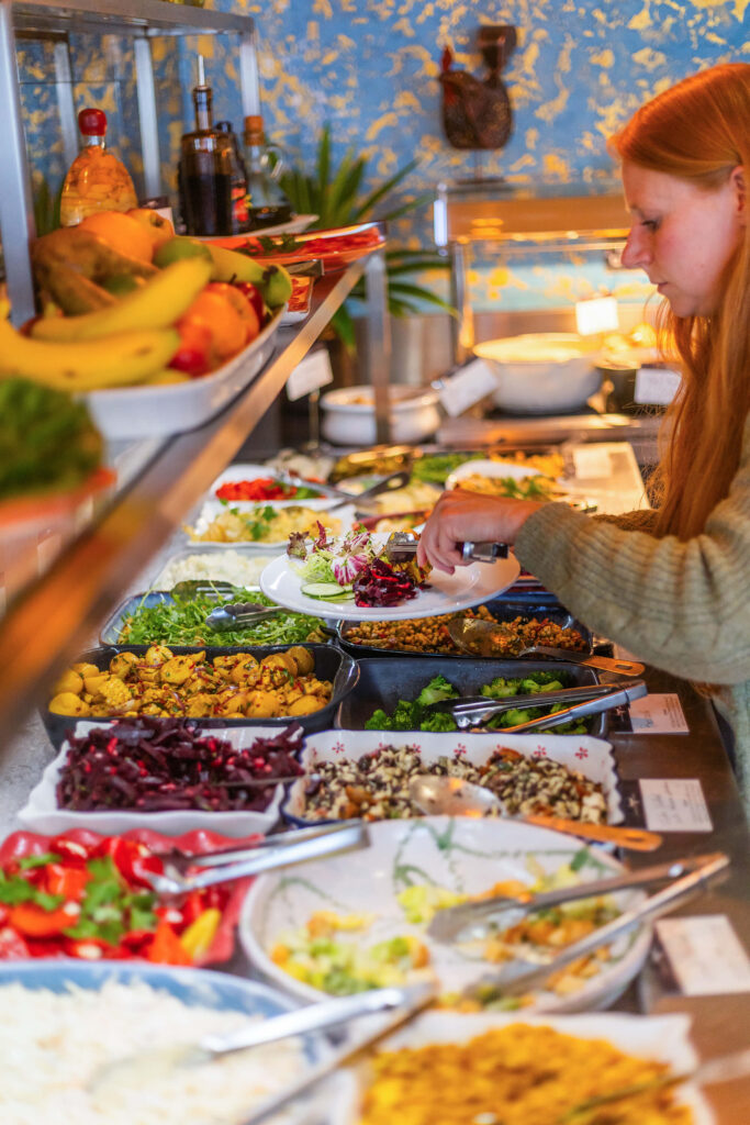 Customer serving fresh salad and side dishes from the buffet at Casa Brazilian Rodizio in York.